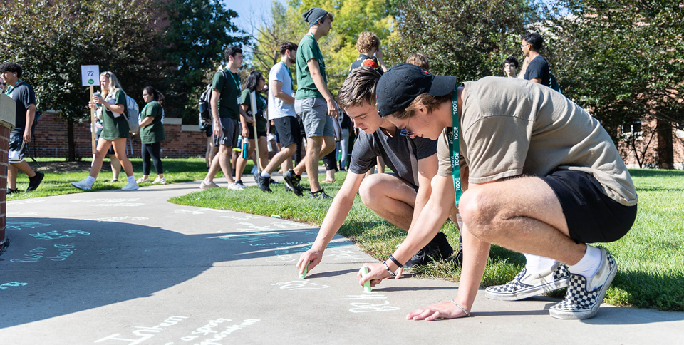 Students chalking their college goals around Aspiration Fountain