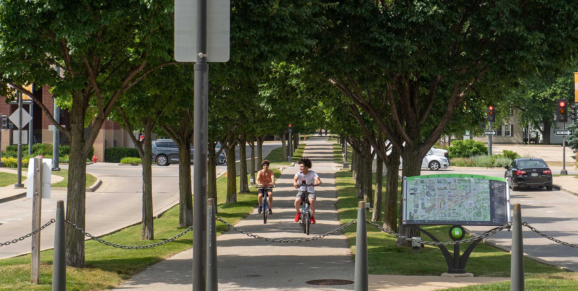 Two people riding bicycles on Constitution Trail in Uptown Normal