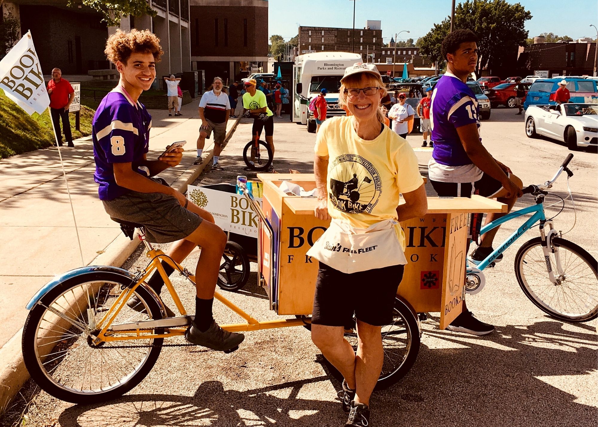 Karen schmidt standing in front of Book Bike - mobile library on bicycle