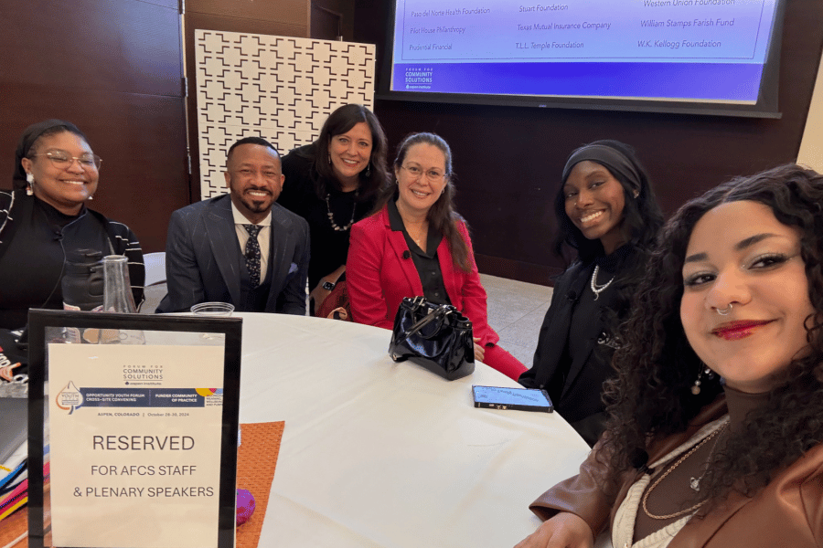 Cloud Benn '25 sits at table with other panelists ahead of Aspen Institute event