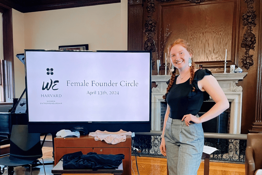 Marissa Hagler in wood-paneled room at Harvard giving a presentation