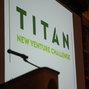 titan new venture challenge presentation with microphone