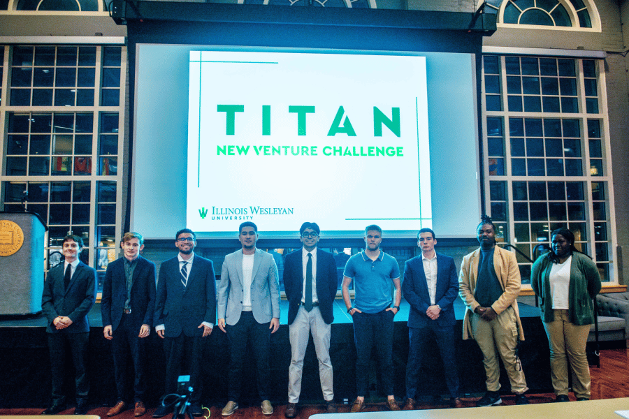 students on stage at the titan new venture challenge in hansen student center