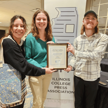 IWU students pose with ICPA award