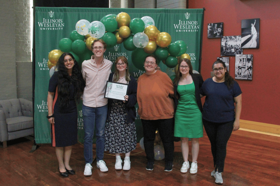 Students with IWU's Awareness, Wellness, Education RSO pose with award