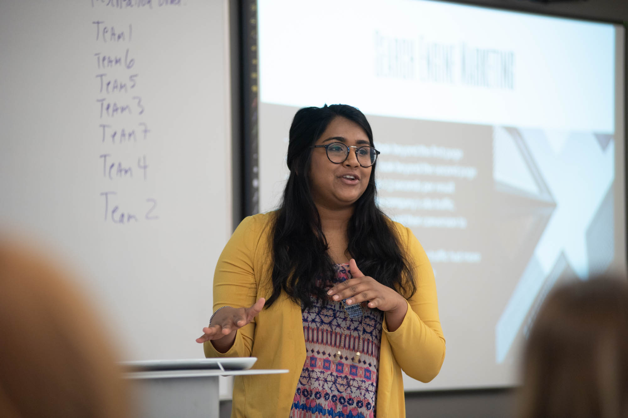 person presenting in front of a projection